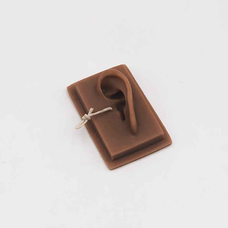 Brown earbud case with a white cord on a light gray background