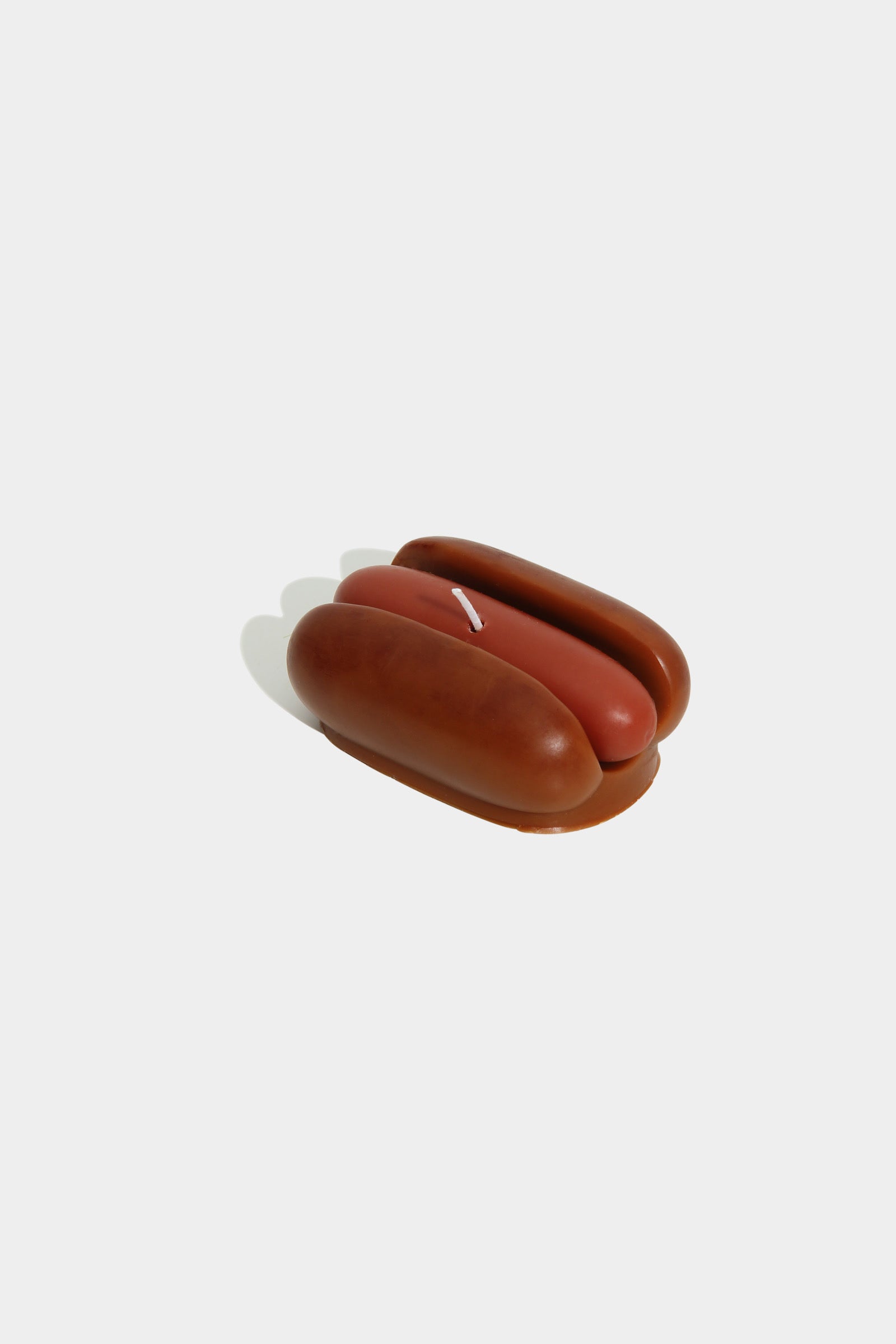 Small brown ceramic object on a white background