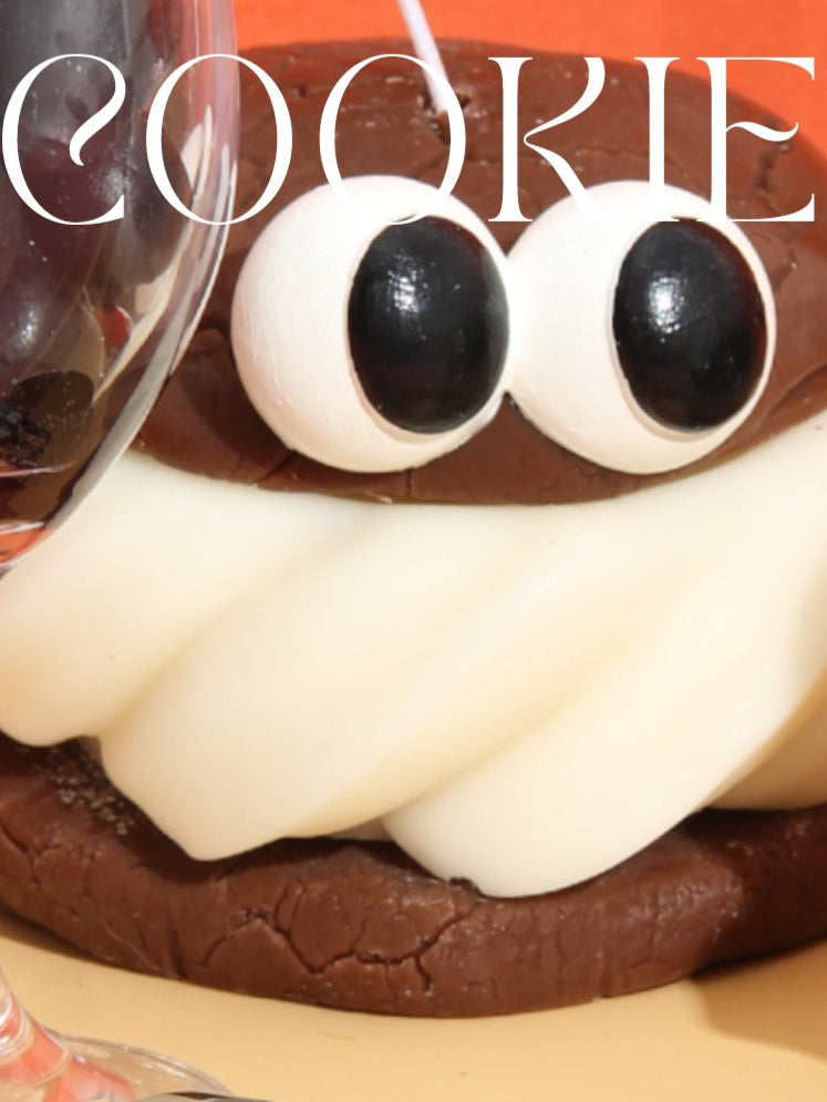 Cookie with eyes and a mouth on a red background with 'COOKIE' text.