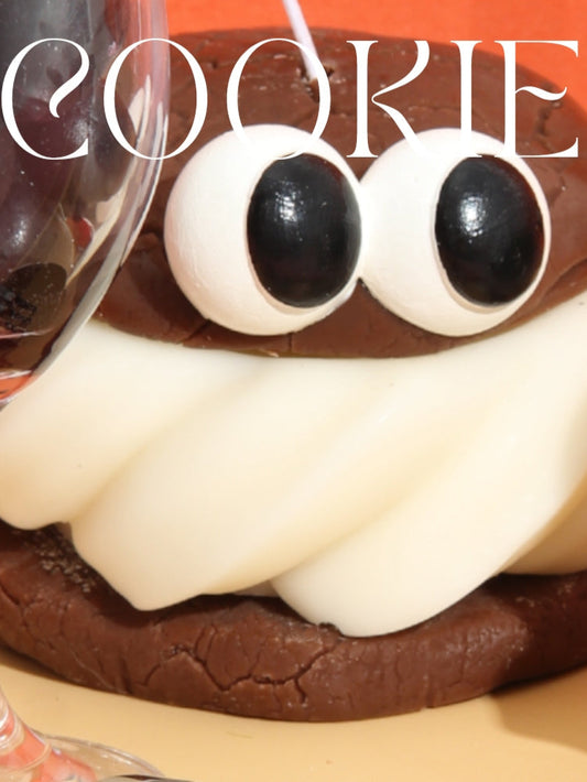 Cookie with eyes and a mouth on a red background with 'COOKIE' text.