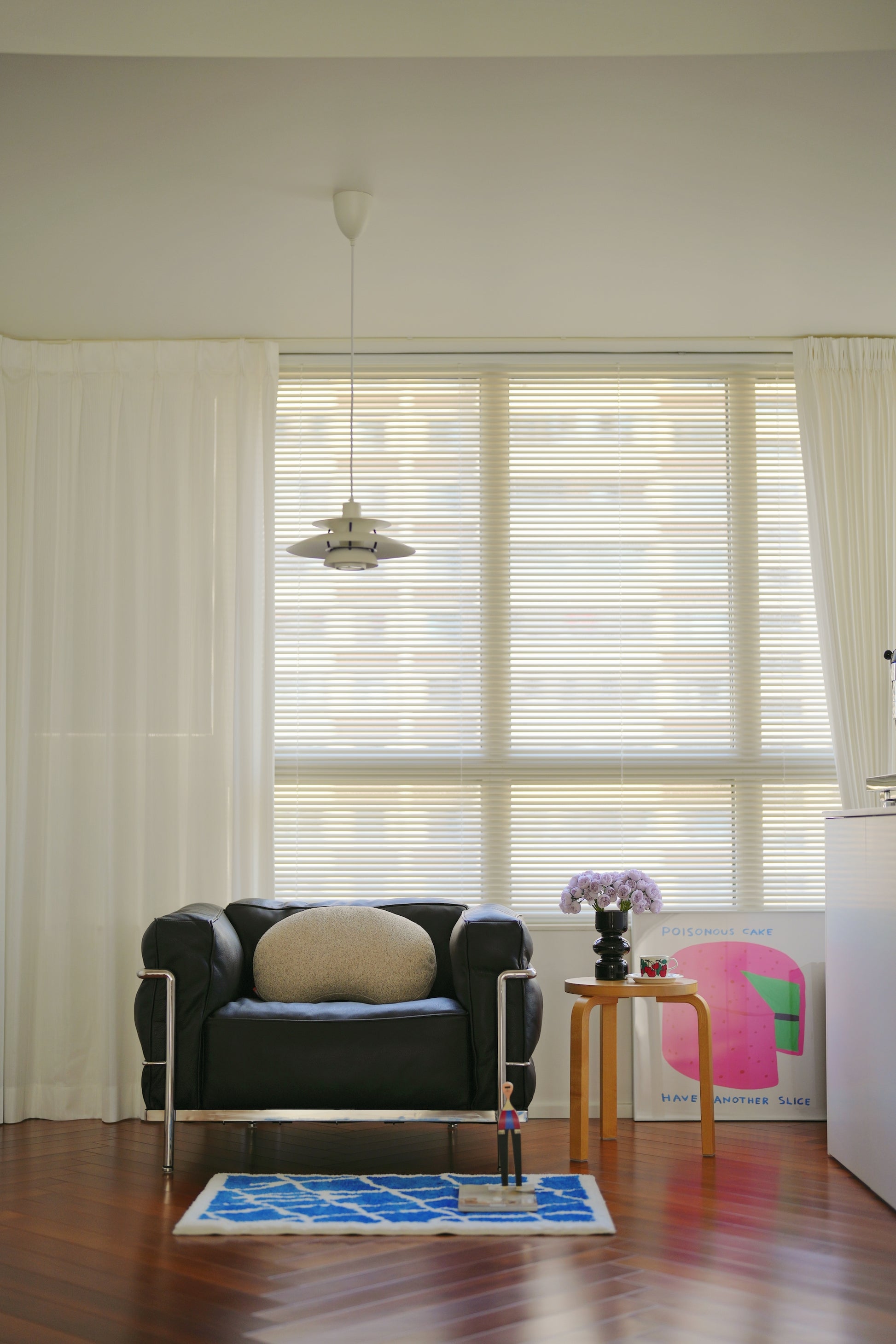Living room with a black sofa, small table, and decorative items.