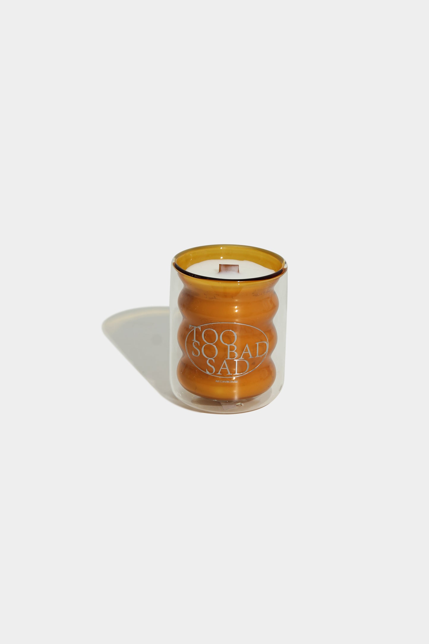 Candle in a glass jar with text on a white background