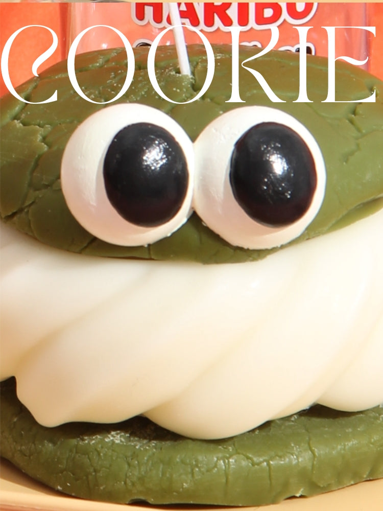 Green cookie with googly eyes and the brand name 'Haribo' visible