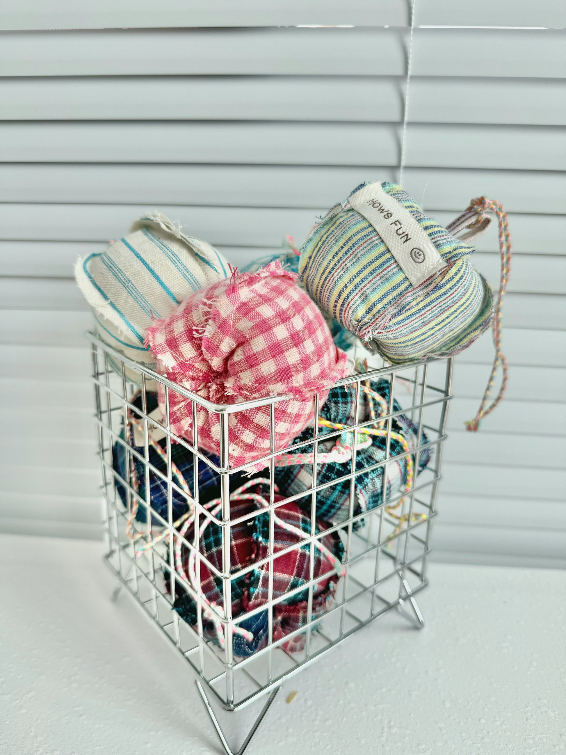 Basket with yarn and fabric items against a neutral background