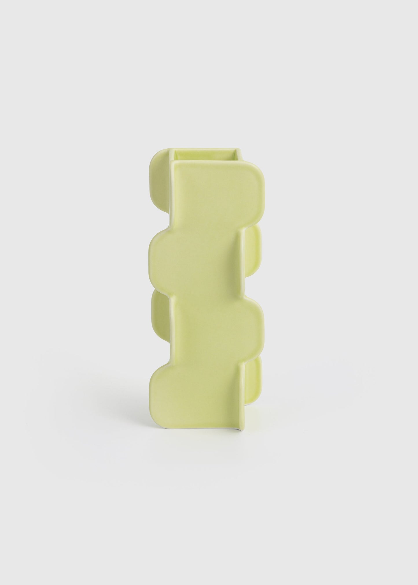Yellow geometric vase on a white background