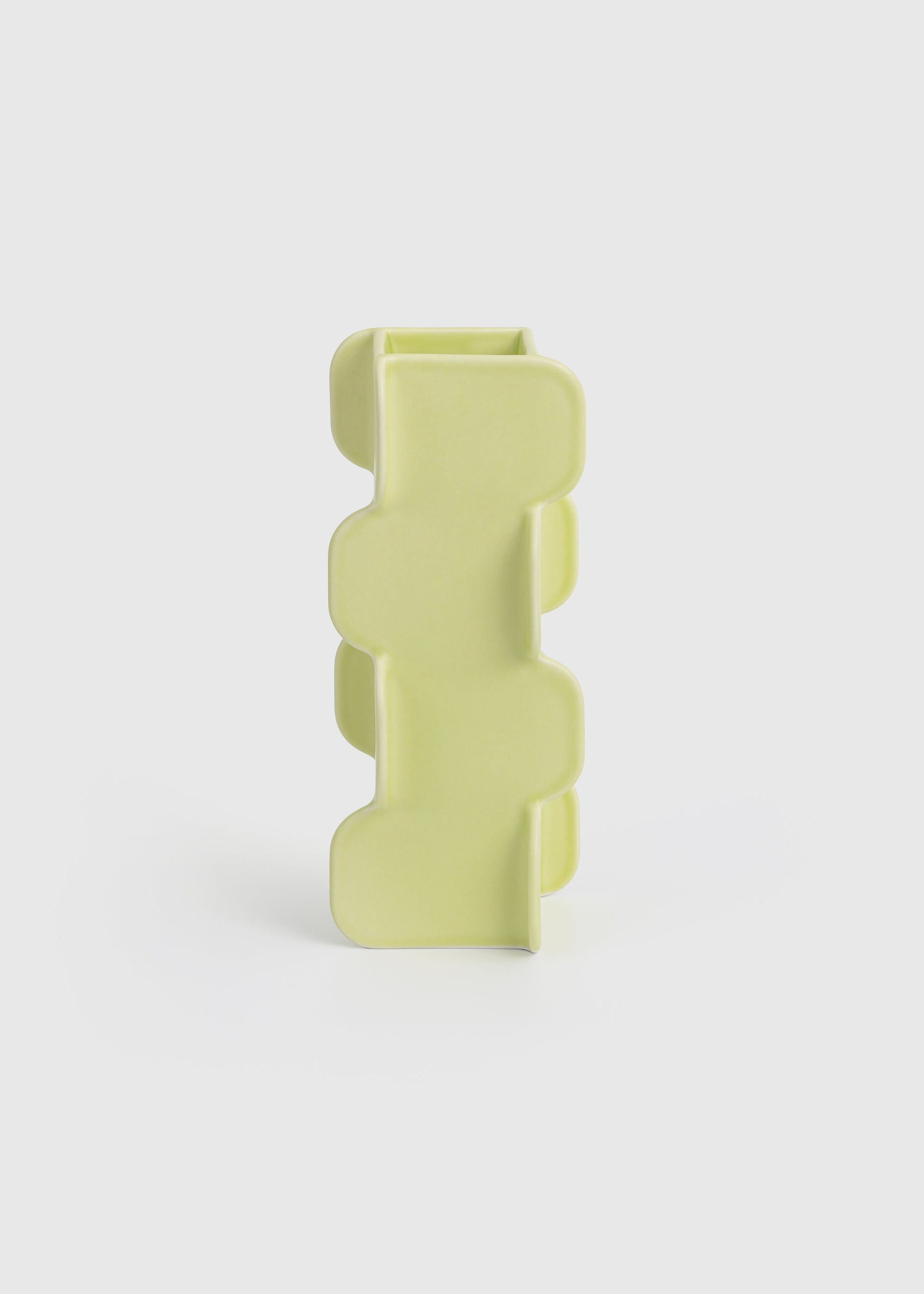 Yellow geometric vase on a white background