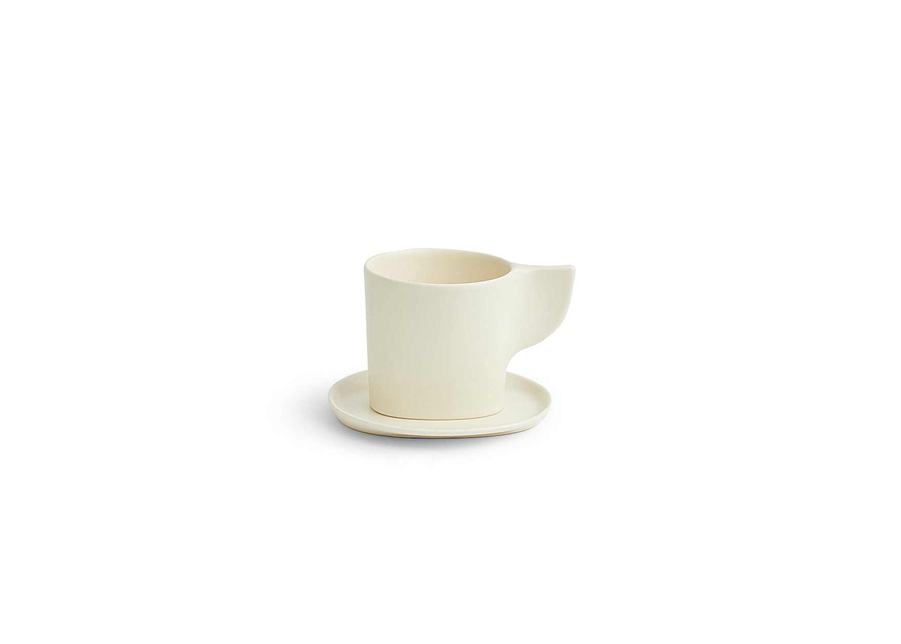 White ceramic pitcher with a matching saucer on a white background