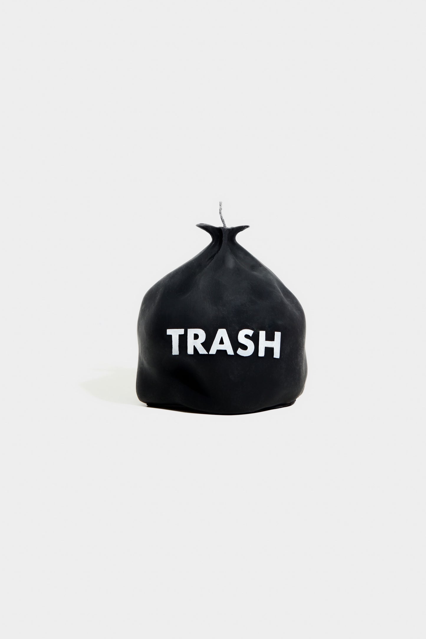 Black trash bag with 'TRASH' text on a white background