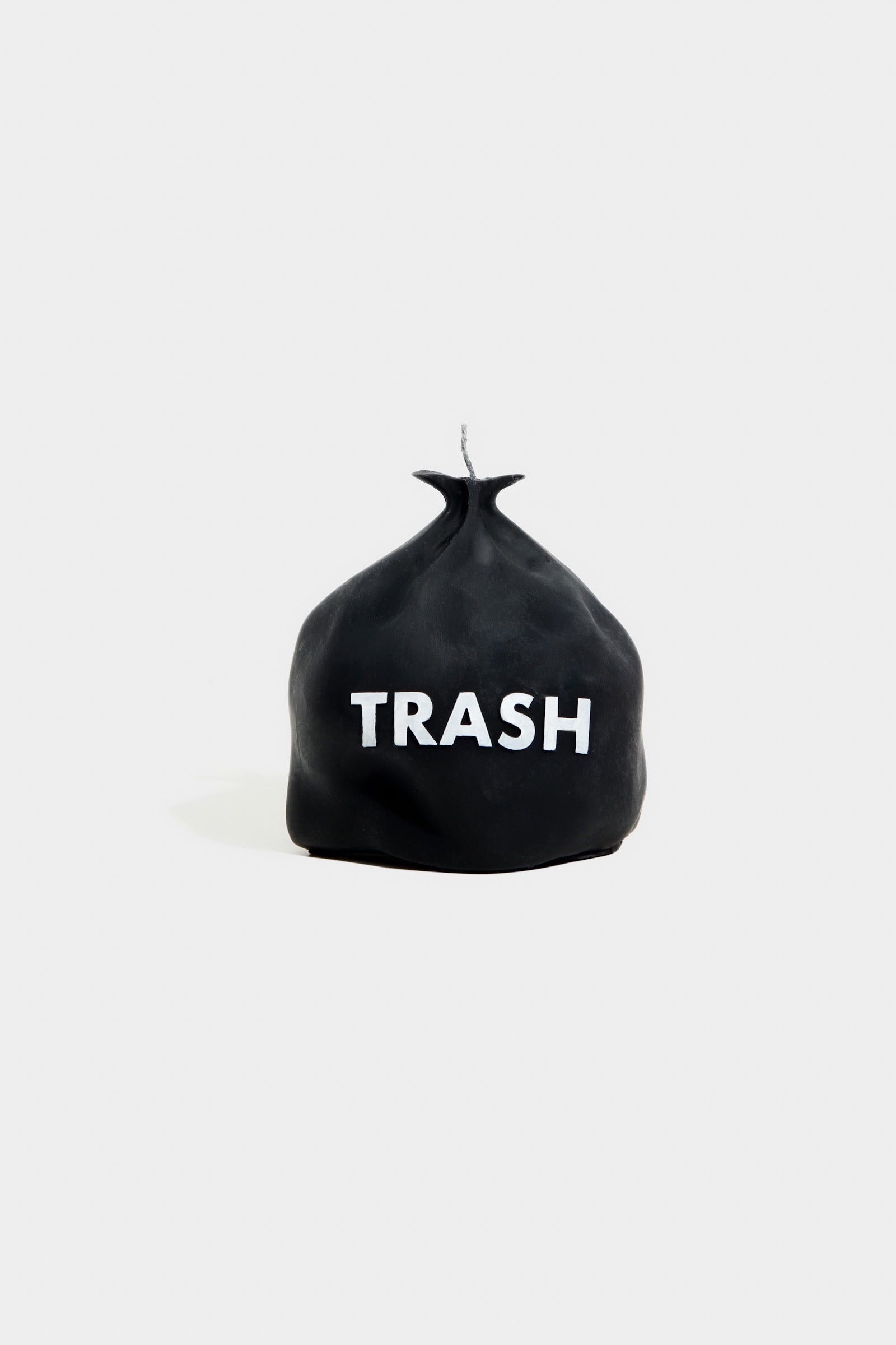Black trash bag with 'TRASH' text on a white background