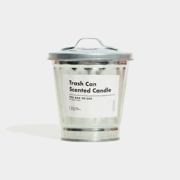 Trash can-shaped scented candle with a label on a white background
