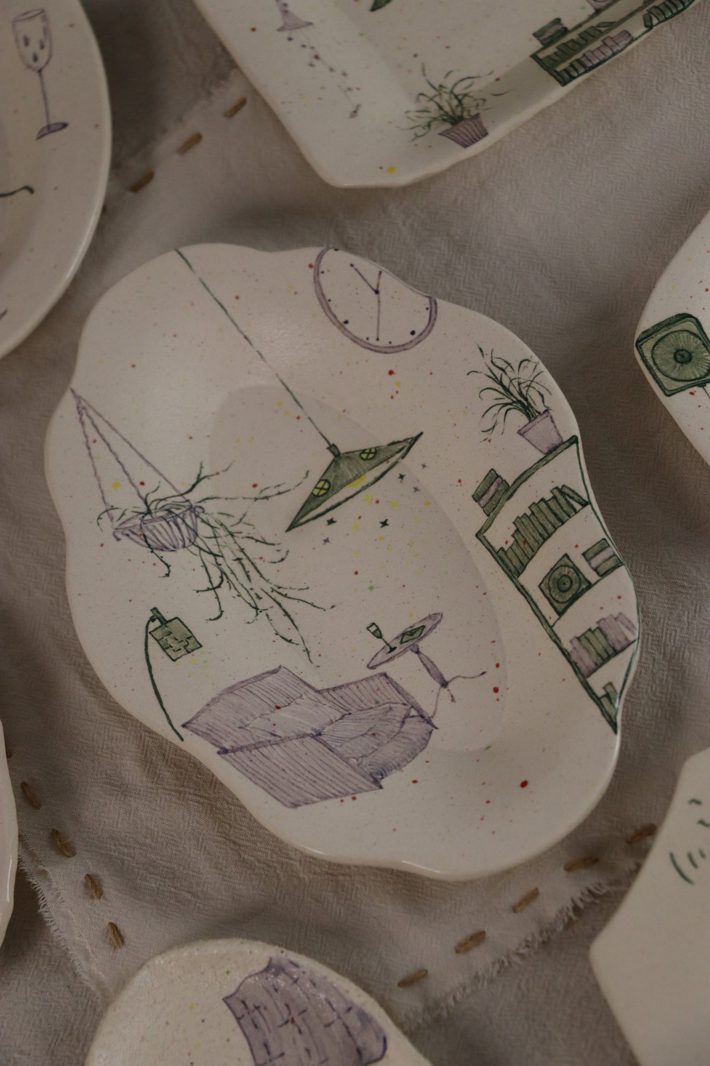 Decorative ceramic plates with artistic designs on a textured surface