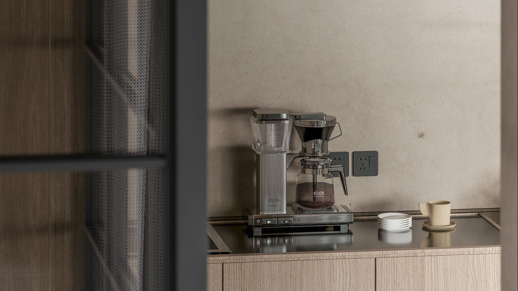 Coffee machine on a kitchen counter with a neutral wall background