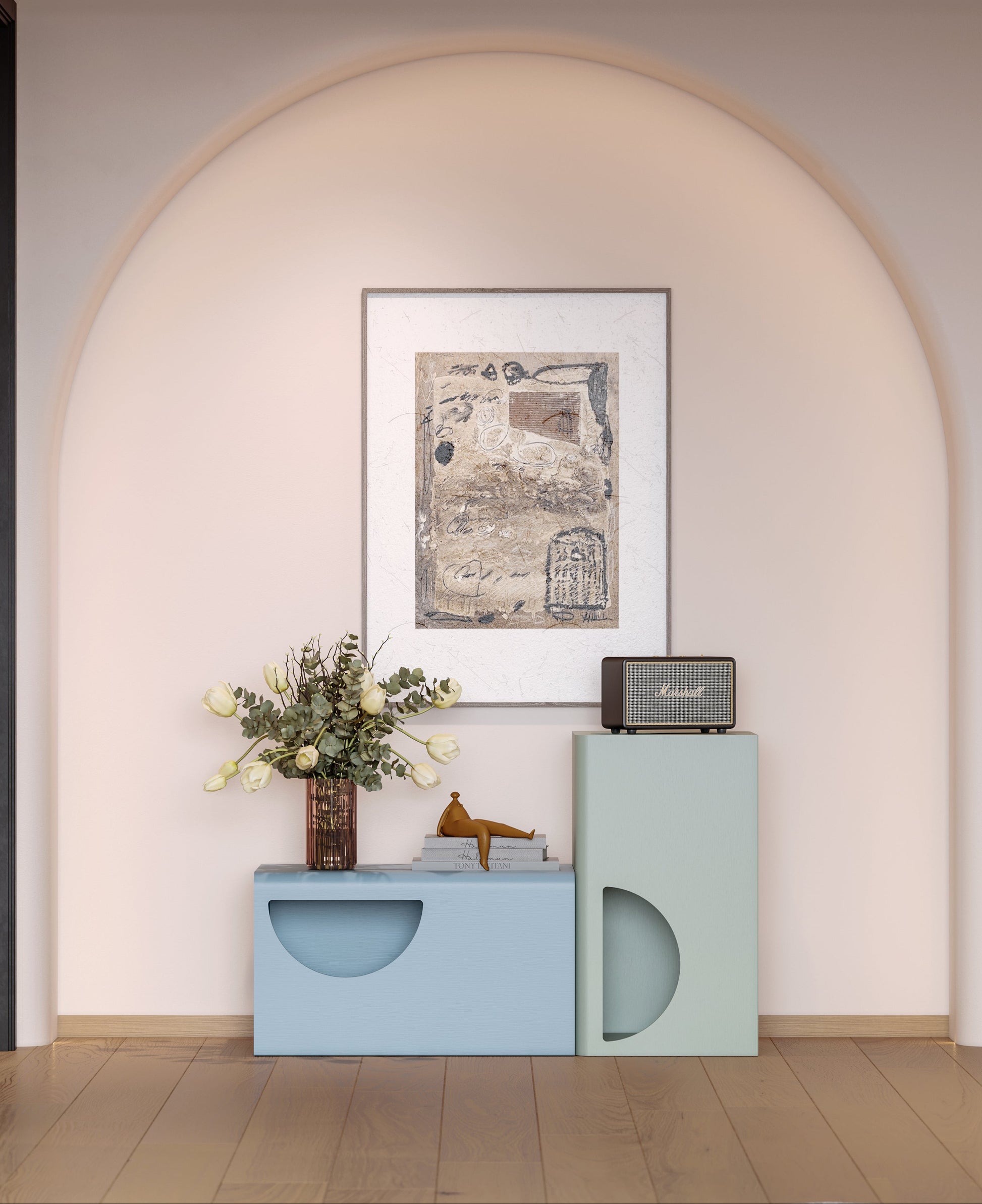 Decorative setup with a framed picture, vase, and small table against a light pink wall.