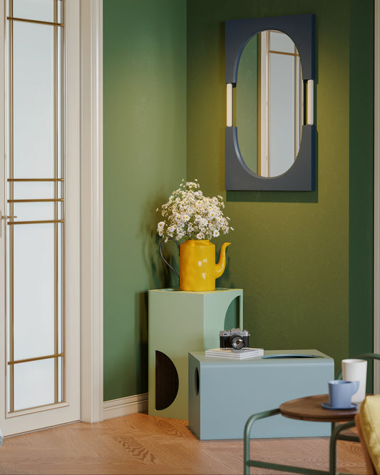 Modern interior design with a green wall, mirror, and decorative items.