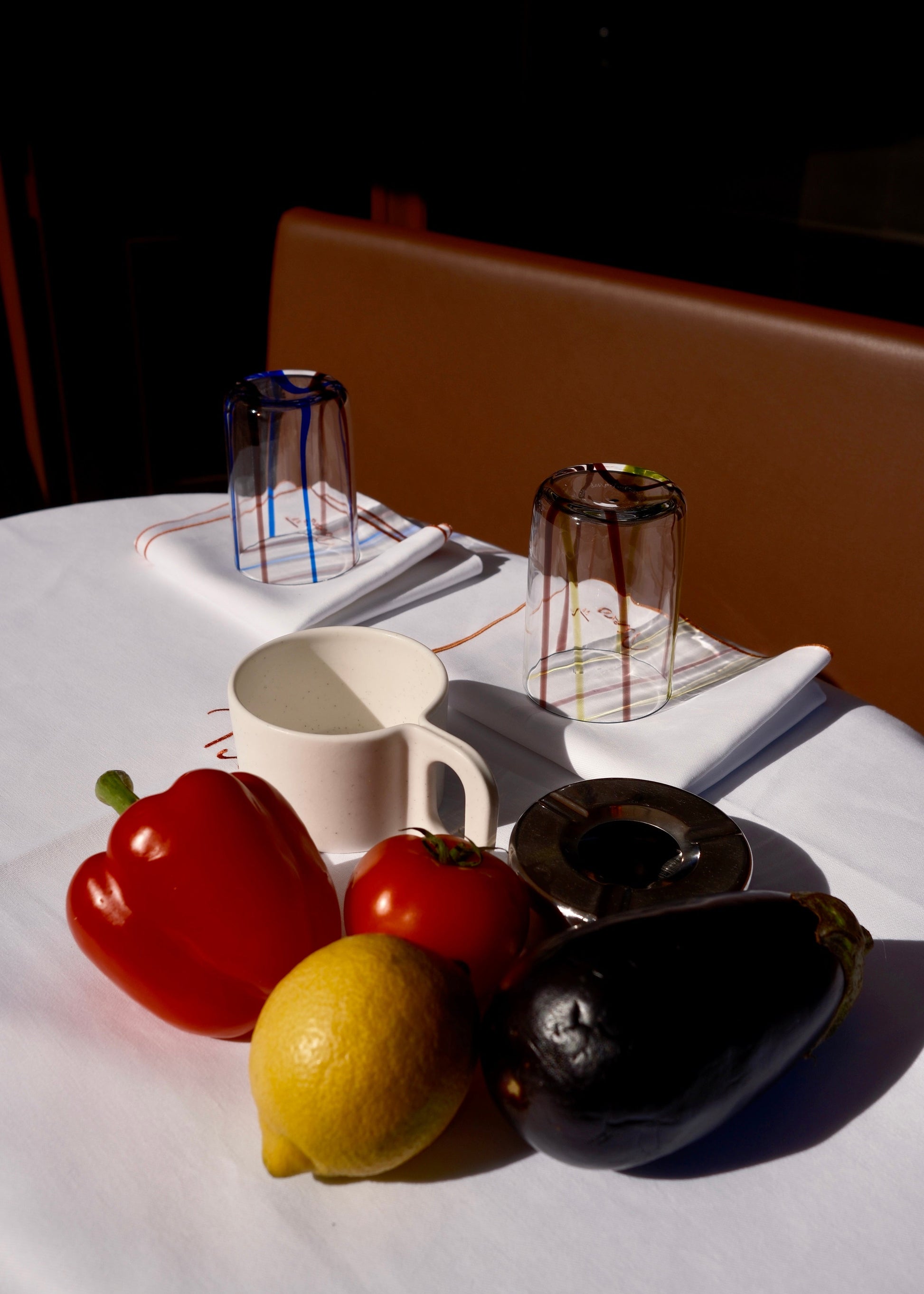 Fruits and vegetables on a table with a white tablecloth