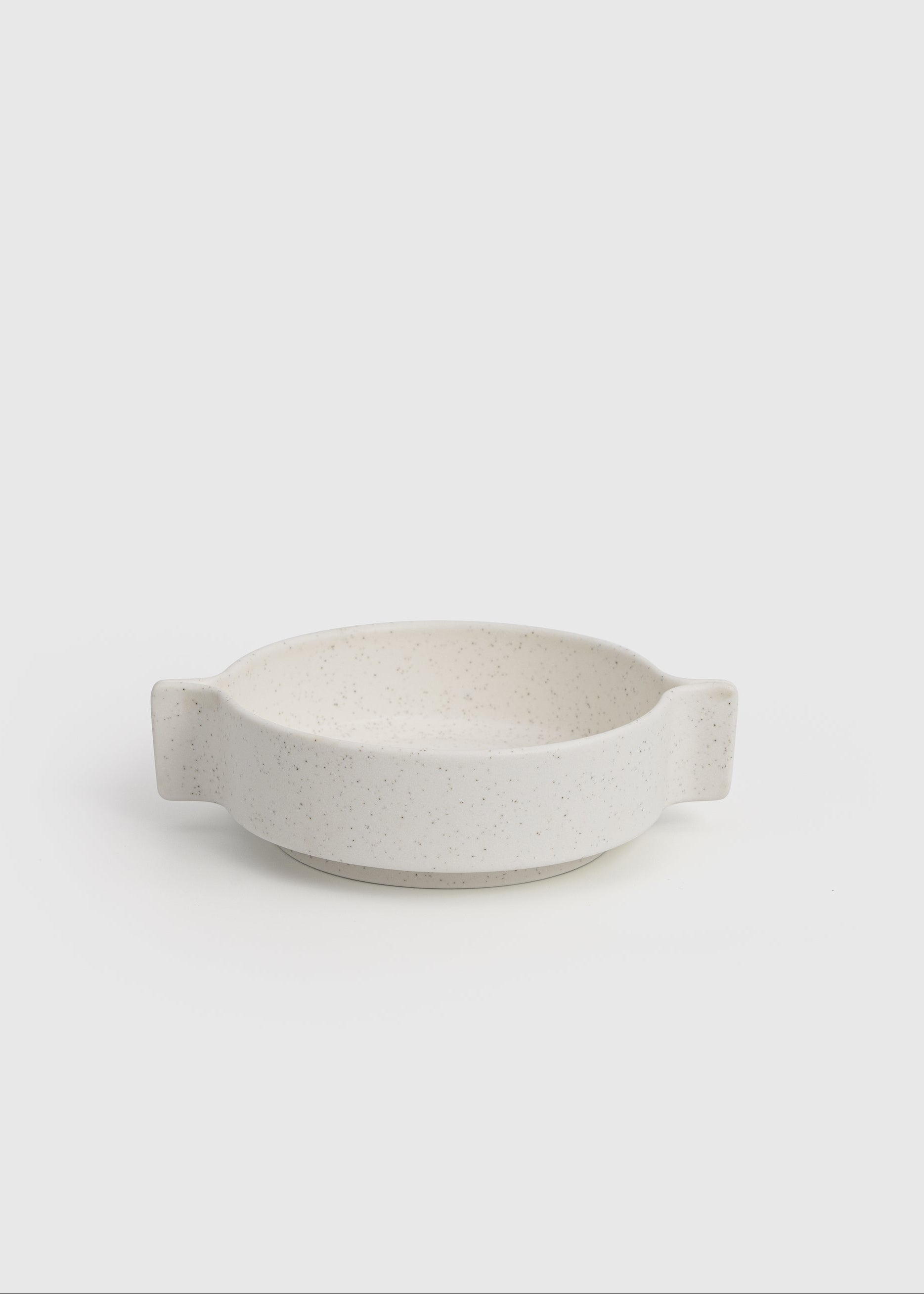 White ceramic bowl on a light gray background