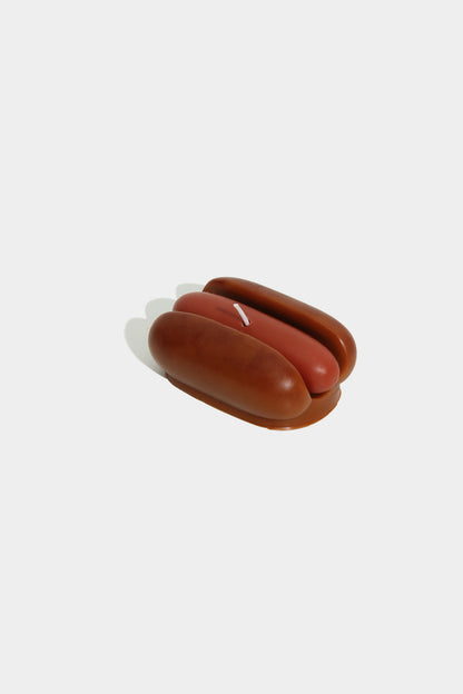 Small brown ceramic object on a white background