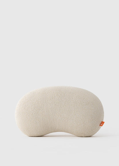 Beige eye pillow on a light gray background