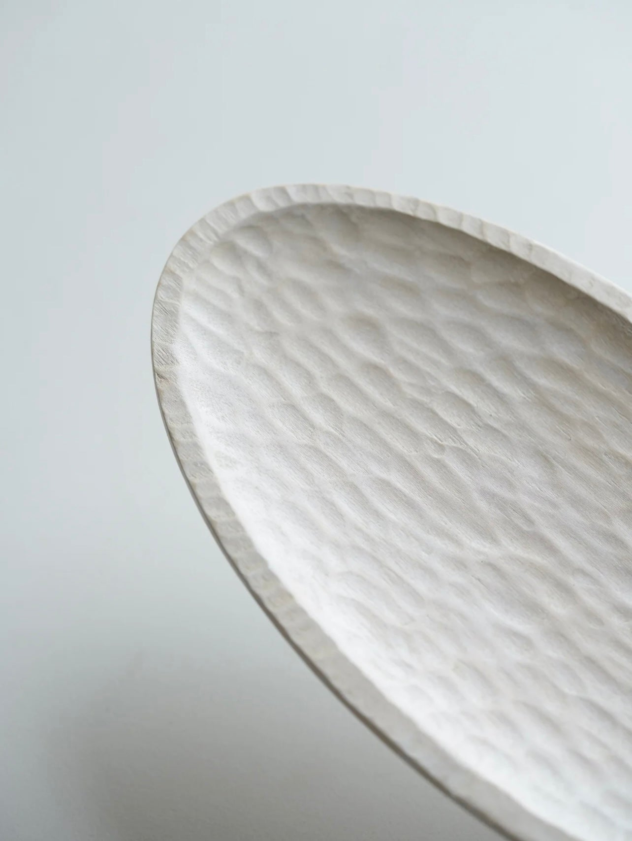 Close-up of a marble-patterned oval dish on a light gray background