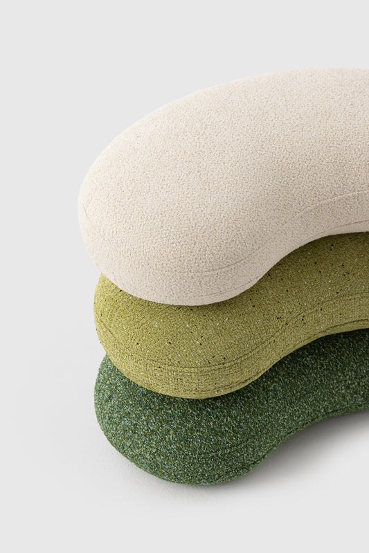 Three textured cushions in beige, green, and olive on a light gray background