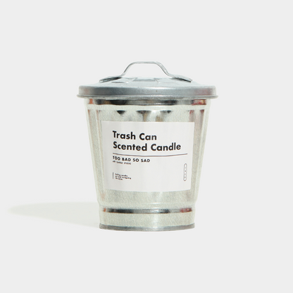 Trash can-shaped scented candle with a label on a white background